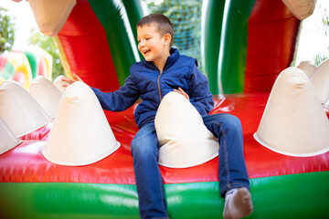 Fototapeta na wymiar Boy Laughing on Bouncy Castle