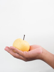 A pear is held in a hand with a white background