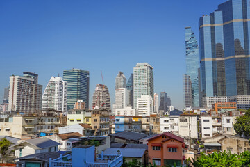 Panoramic city skyline of Bangkok with slums on the foreground. Contrasts of a rapidly developing...