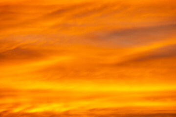 Bright orange evening sky background at sunset.