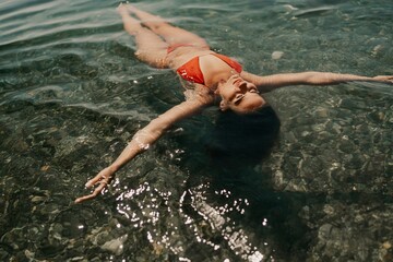 Happy woman sea relaxing floating in transparent sea water on summer holiday. Travel leisure recreation lifestyle, female in nature.