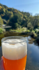 Cold glass of beer in front of scenic view