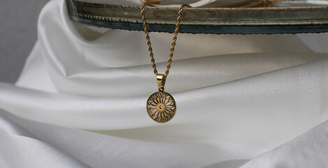 modern, lifestyle-appropriate jewelry, accessories. Necklaces in golden yellow stainless steel,...