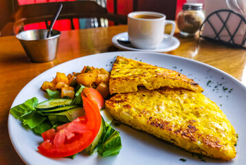 Tortilla espanola with Salad and potatoes on plate in Mexico.