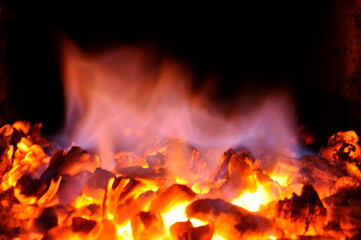 Hot red charcoal in the furnace firebox.