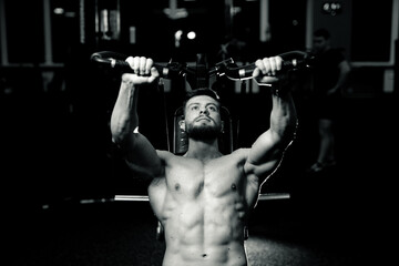 Fototapeta na wymiar Bodybuilding young man in gym. Training muscular shirtless man.