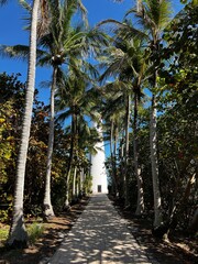 Tall Whitewashed Lighthouse. Ship Transportation