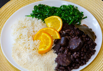 Traditional Brazilian feijoada served on a white round plate