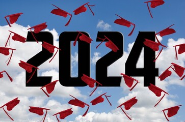 Airborne red graduation caps for 2024 in the sky with white clouds 