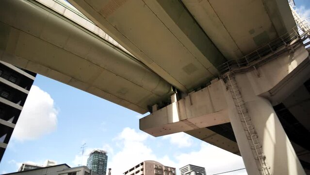 A highway passing through the TKP Gate Tower Building in Osaka, Japan. Freeway passing through a skyscraper. High quality 4k footage