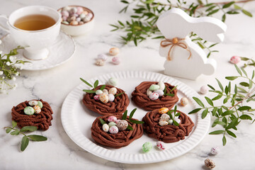 Easter chocolate shortbread cookies in a shape of nest filled with colorful egg candies. Delicious...