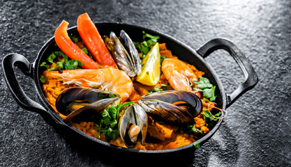 Seafood paella served in a cast iron pan