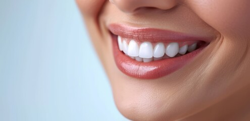 Obraz premium close-up of a women smilingon a blue background with space for text , Teeth whitening. Dental clinic patient. Stomatology concept