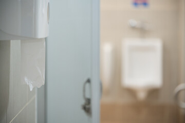 Selective focus toilet tissue paper in white box for cleaning hand on white wall background.