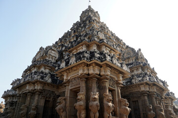 Gopuram of ancient temple against sky. Tall Tower with Sandstone carved God and Lion sculptures at historic Kanchi Kailasanathar temple in Kanchipuram, Tamilnadu.