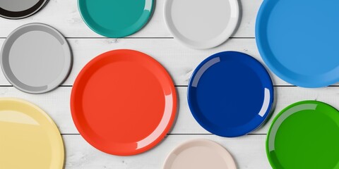 Collection or arrangement of colourful empty porcelain plates on white wooden table background, flat lay top view from above