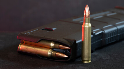 An assault weapon magazine and a bullet