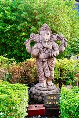 Ganesha Traditional statue with in garden. Lord Ganesha is believed to bring good luck and thus he...