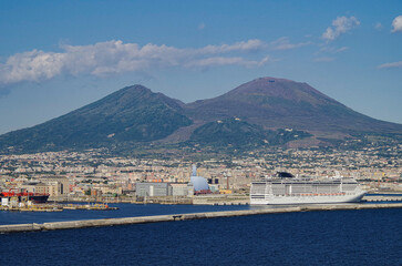 Mega modern cruise ship cruiseship liner Preziosa in port of Naples Napoli, Italy with Vesuv volcano panorama for Mediterranean summer cruising