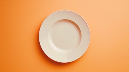 A top view of an empty ceramic plate, elegantly simple, set against a subtle pale orange background