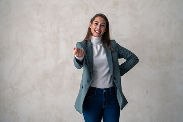 Studio portrait of a young business woman with an outstretched hand inviting you to come and join...