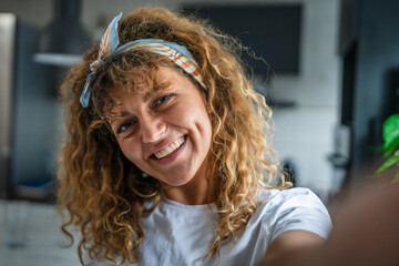 Close up portrait of one adult woman with curly hair happy smile