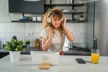 Woman sit at home use digital tablet to watch movie or have video call