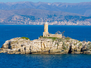 View of Peristeres Kaparelli  lighthouse beacon on an island in the Ionian sea, Greece, seen from...