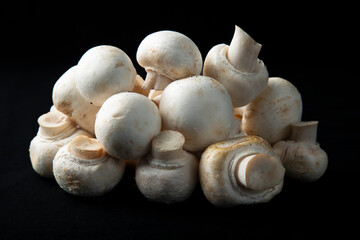 Mushrooms on a black background.Sale of mushrooms and champignons.