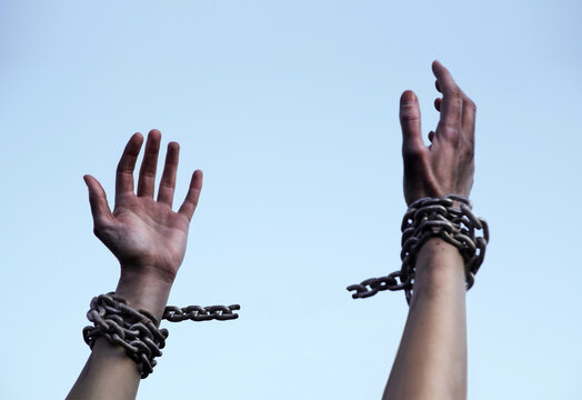 Praying man with shackled hands