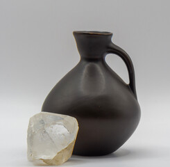 Modern clay jug for water or wine  and quartz crystal