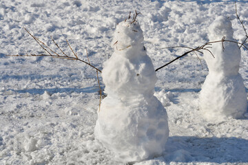 Two snowmen in the park in winter