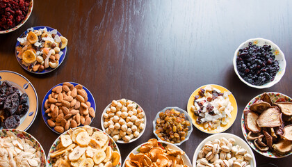 Fototapeta na wymiar Nuts, seeds and dried fruits on the table