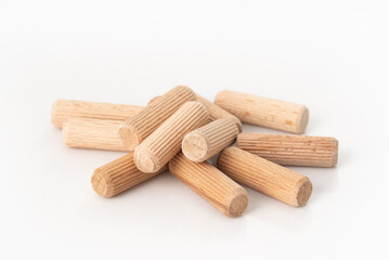 Wooden dowels on white background for connection on chipboards.