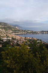 Fototapeta na wymiar A panoramic view of Villefranche-sur-Mer and the Mediterranean sea from the Boron Mount. Nice, France, December 26, 2023.