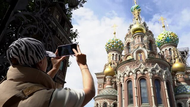 St. Petersburg, Russia, June 04, 2023: A tourist girl photographs the sights of St. Petersburg