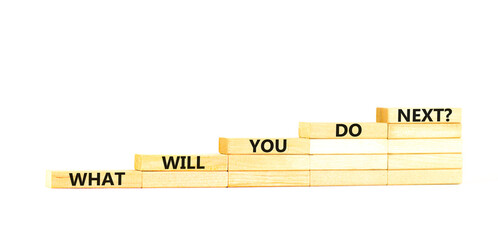 What will you do next symbol. Concept words What will you do next on wooden blocks stairs. Beautiful white table white background. Business, what will you do next concept. Copy space.