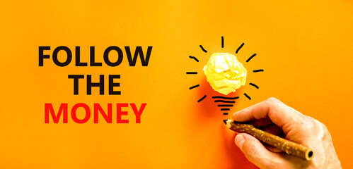 Follow the money symbol. Concept words Follow the money on beautiful orange paper. Beautiful orange...