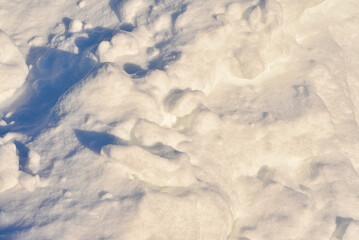 Lumps of snow in winter. Snow and light during the day. Snowdrifts.
