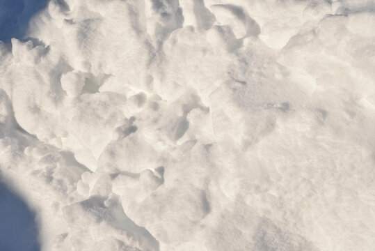 Lumps of snow in winter. Snow and light during the day. Snowdrifts.