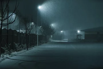 Fotobehang Night street in cold winter snowstorm © chaossart