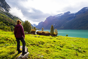 Women and Traditional houses in Lovatnet lake valley in Norway, Europe