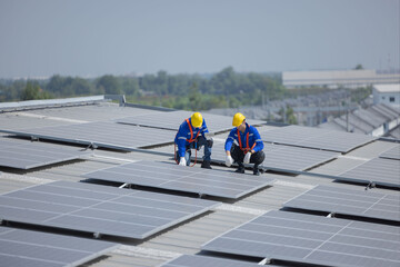 caucasian engineer checking on solar panel on the factory rooftop - obrazy, fototapety, plakaty