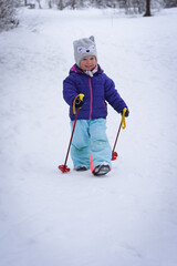 Child skiing in mountains. Little toddler kid on skis for the first time. Winter sport for family.