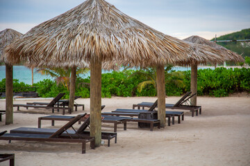 Beach lounge chairs and huts along the beach 