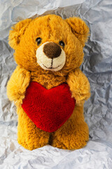 Teddy bear with a heart, vintage tone, concept of love, Valentine's Day holiday. Mothers Day
