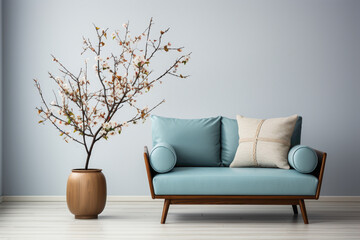 Step into a serene modern living room featuring a cute blue loveseat sofa or snuggle chair paired with a pot holding a branch, set against a minimalist white wall with generous copy space. 