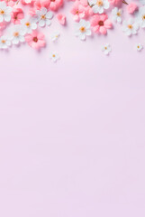 Soft pink flowers on a light background. Spring background, flowers, top view with copy space. Natural background