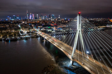 Swietokrzyski Bridge over the Vistula River with a panoramic view of the center of Warsaw at night. Poland - obrazy, fototapety, plakaty