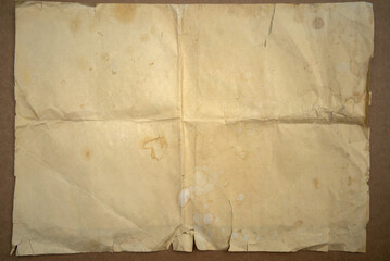 The texture of old paper. A photo of a vintage yellowed piece of paper on the table.A clean antique...
